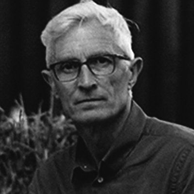A black and white photo of a man wearing glasses