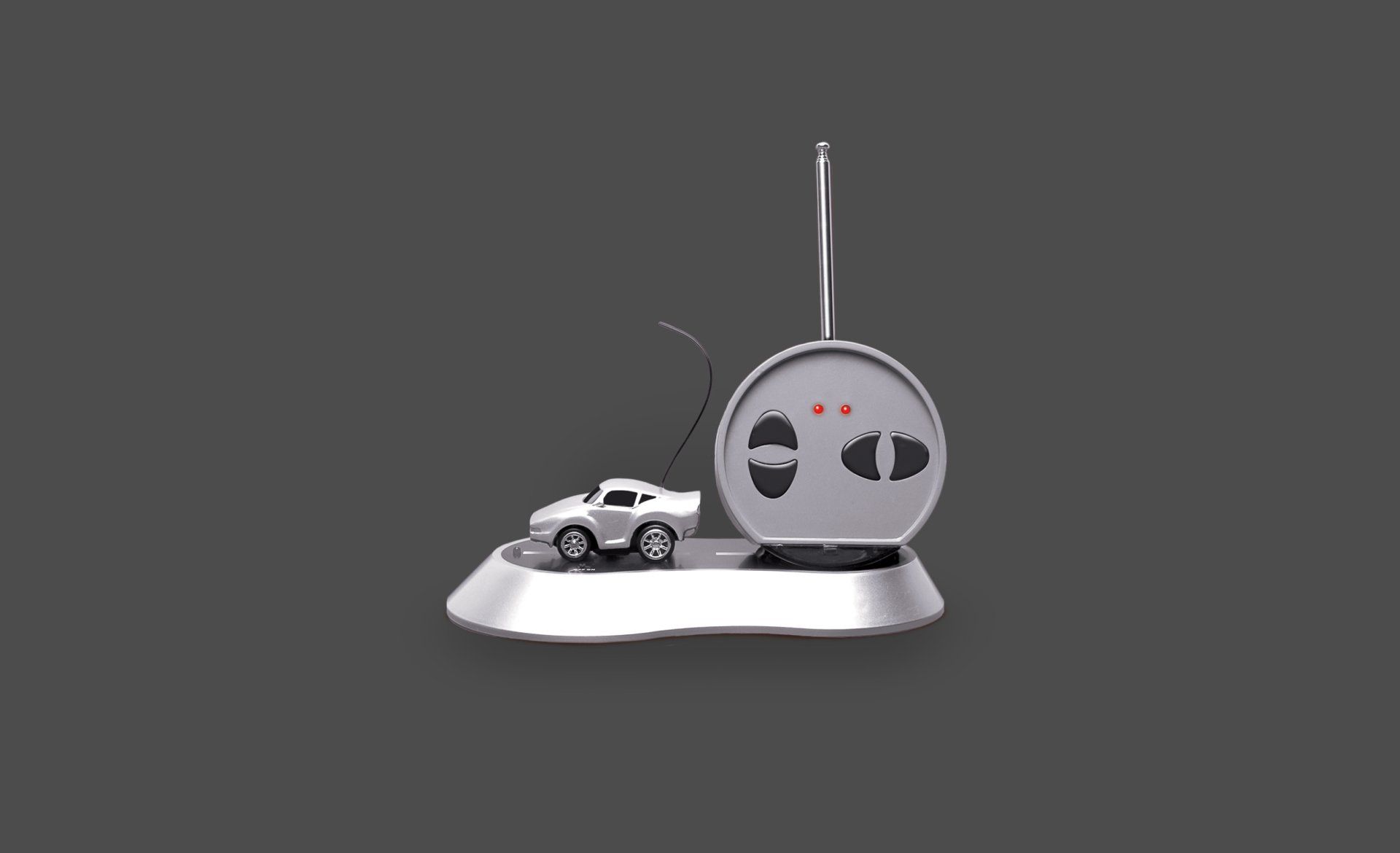 A remote control with a car on top of it