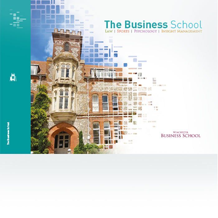 A book cover for the business school shows a large brick building