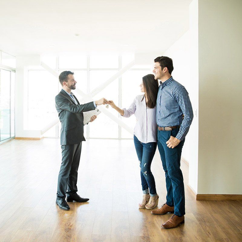 Condo Rentals and Sales — Couple Getting Keys From Realtor  in Phoenix, AZ