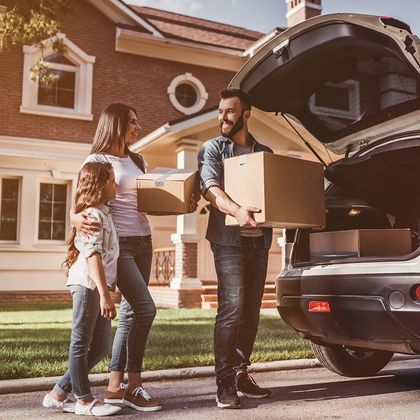 Apartment Rental — Happy Family Holding their Moving Boxes in Phoenix, AZ Apartment Rentals – Phoenix AZ