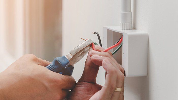 Technician Installing Power Plug — Southern Indiana — Weyer Electric, Inc. Technician Installing Power Plug — Southern Indiana — Weyer Electric, Inc.