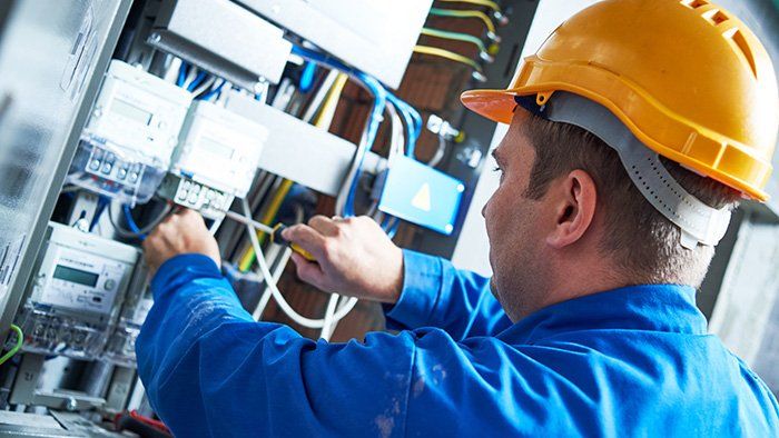Electrician Installing Energy Saving Meter — Southern Indiana — Weyer Electric, Inc. Electrician Installing Energy Saving Meter — Southern Indiana — Weyer Electric, Inc.