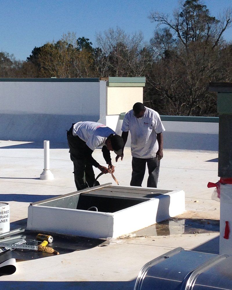 Workers On The Rooftop — Raymond, MS — Mid Mississippi Heating & AC, LLC Workers On The Rooftop — Raymond, MS — Mid Mississippi Heating & AC, LLC