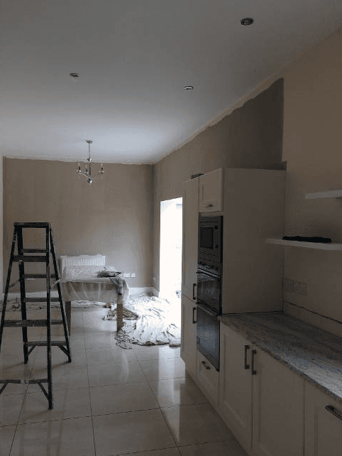 Ladder and decorating materials in a beige and white room