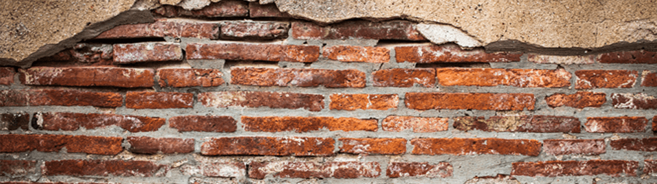 Brickwork showing on a wall in need of plastering