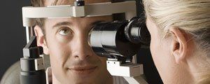 Glaucoma Treatment — Optometrist Doing Sight Testing for Patient in Hutchinson, KS Glaucoma Treatment — Optometrist Doing Sight Testing for Patient in Hutchinson, KS