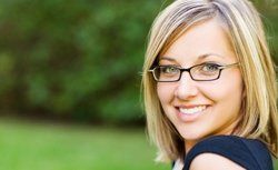 Eye Exams — Pretty Young Woman with Her New Eyeglasses in Hutchinson, KS Eye Exams — Pretty Young Woman with Her New Eyeglasses in Hutchinson, KS