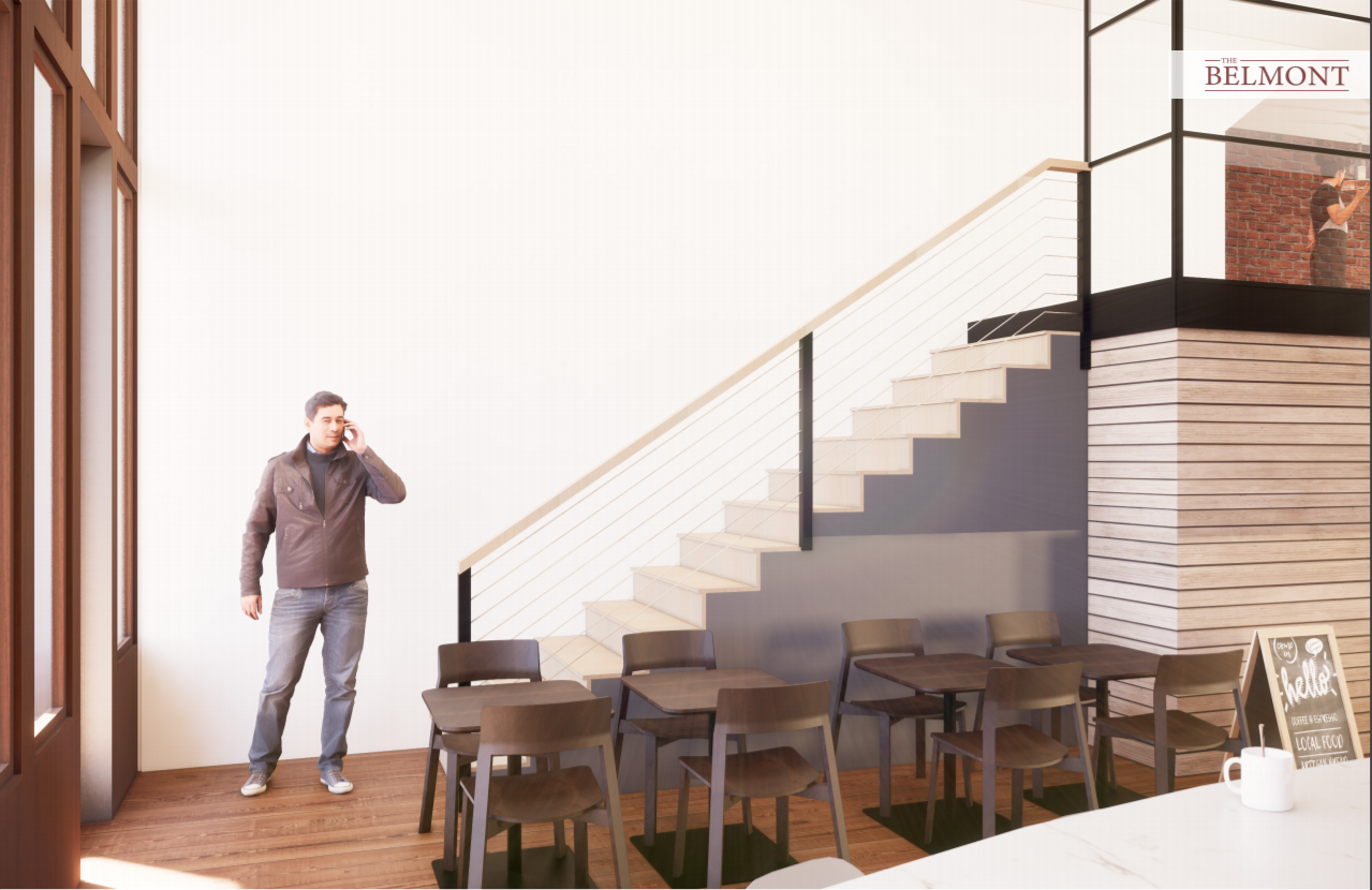 A man talking on a cell phone in a room with stairs