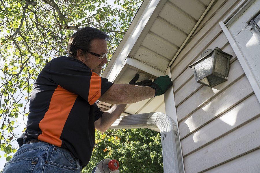 man fixing the gutter system