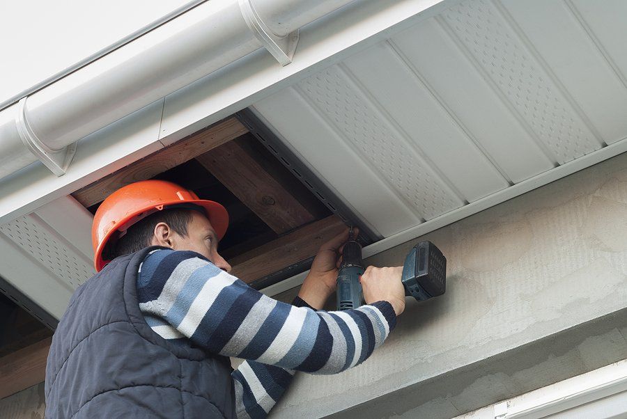 man drilling the exterior ceiling