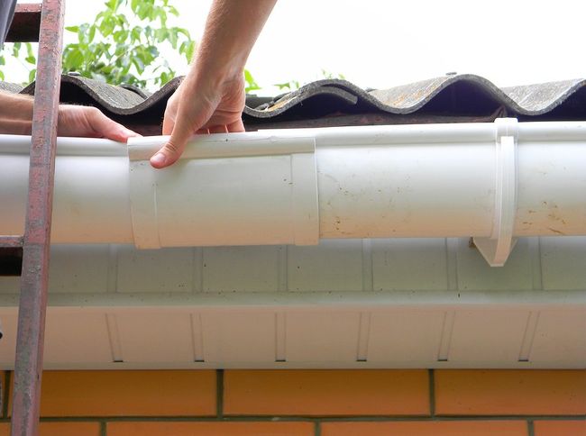 unrecognized person repairing the gutter guard