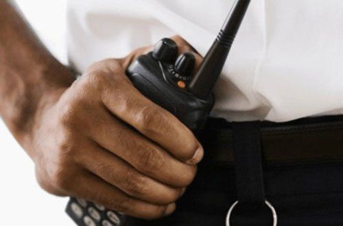Mobile Security Patrols man handling walkie - talkie