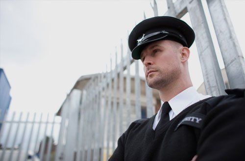 Security Guard in black suite with black cap