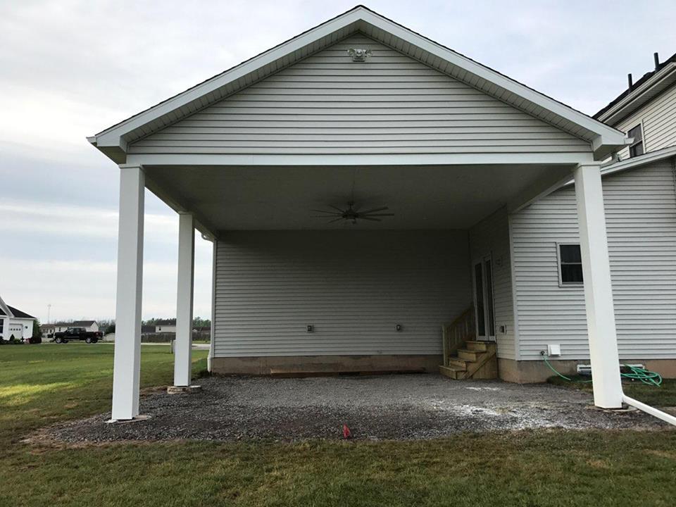 a white house with a carport attached to it .