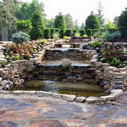 there is a waterfall in the middle of the garden