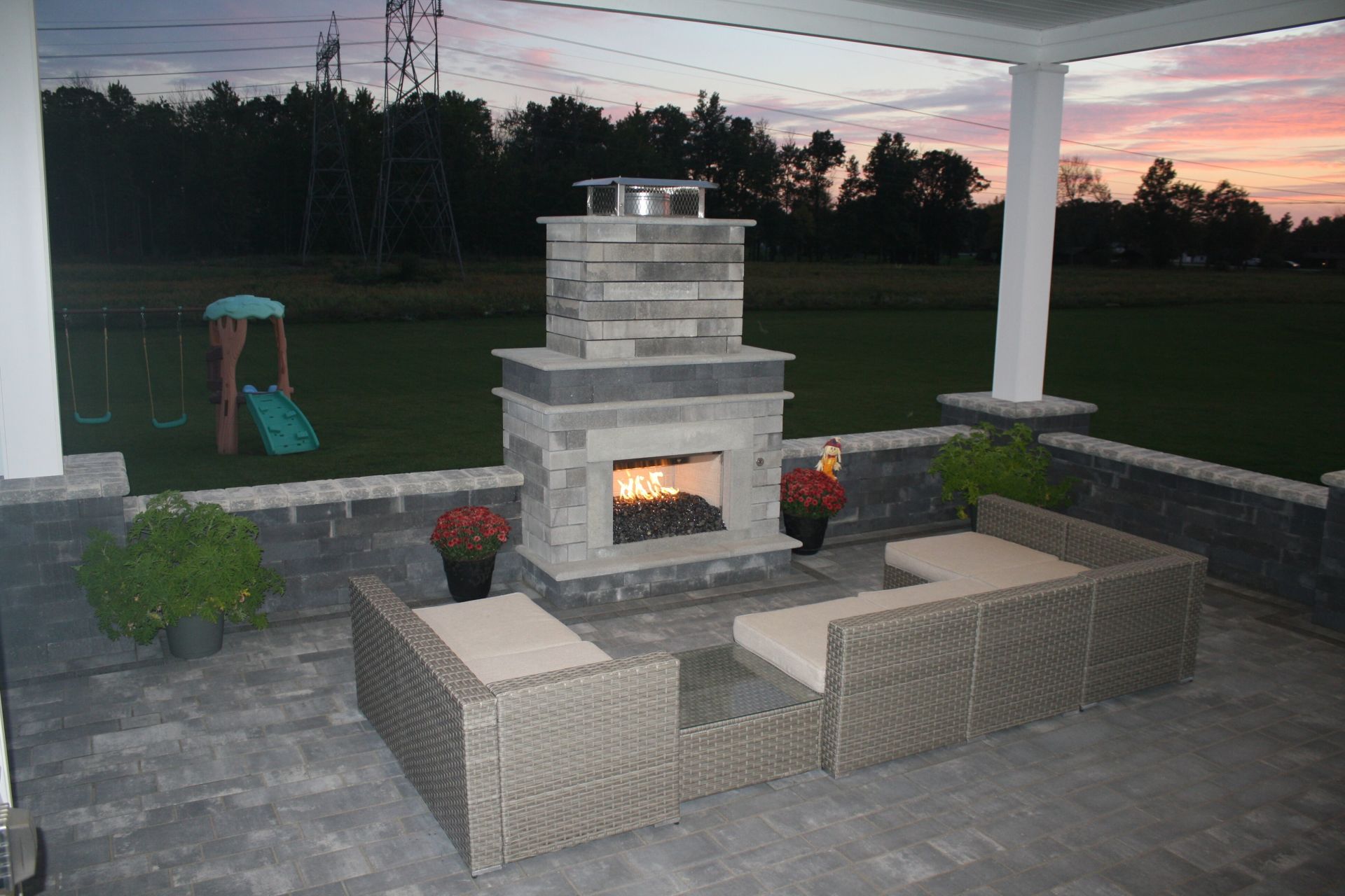 there is a fireplace in the middle of the patio .