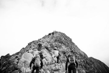 A group of people are hiking up a mountain.