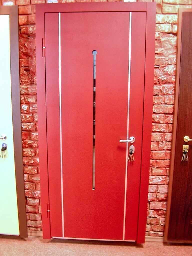 Red exterior door with a vertical window, white trim, brick background.