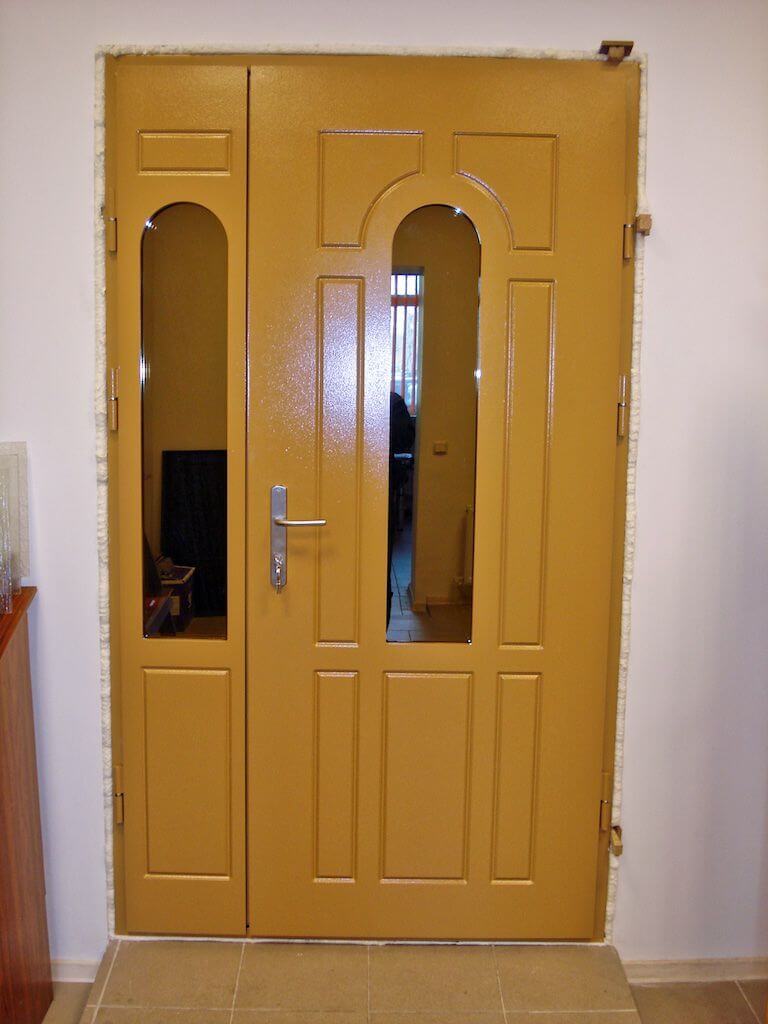 Yellow double door with glass panels; interior view.