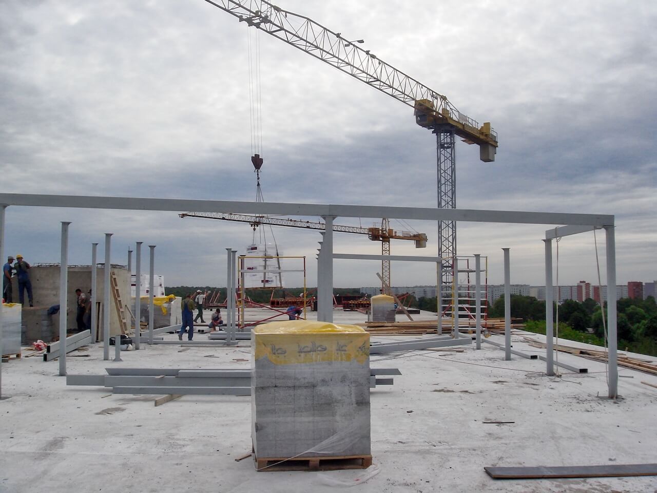 A building under construction with a crane in the background