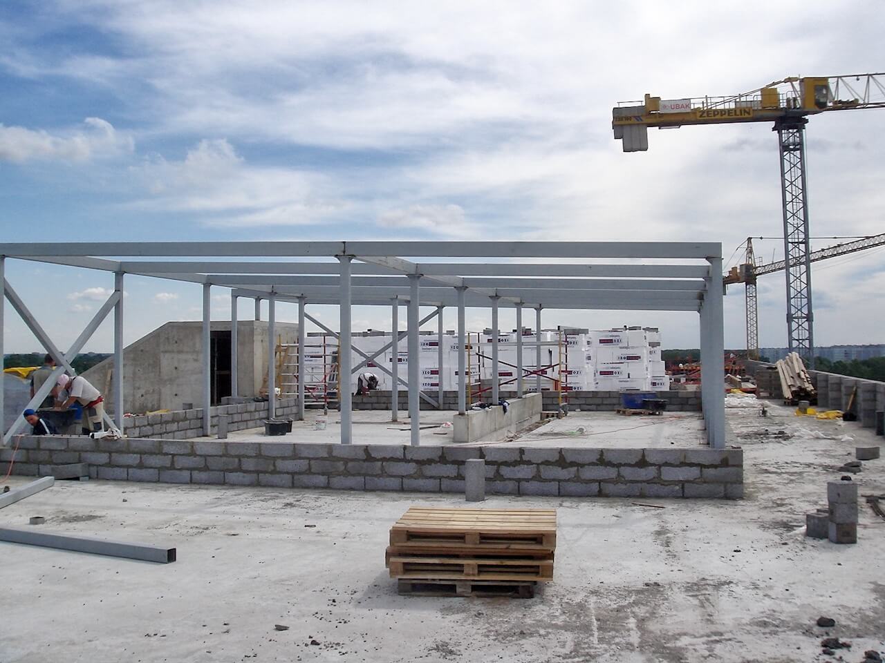 A building under construction with a crane in the background