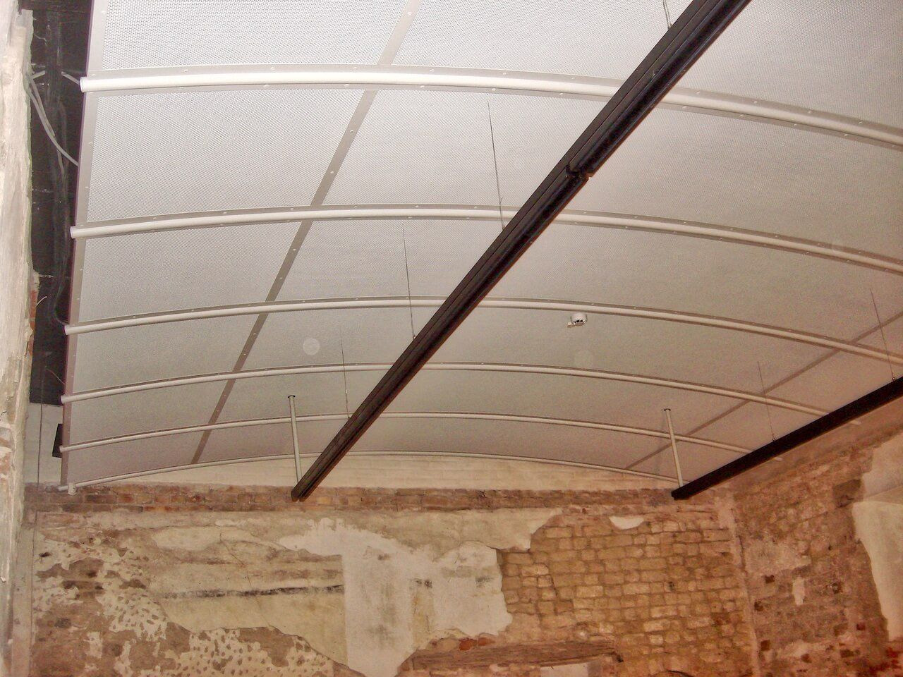 A room with a brick wall and a white ceiling