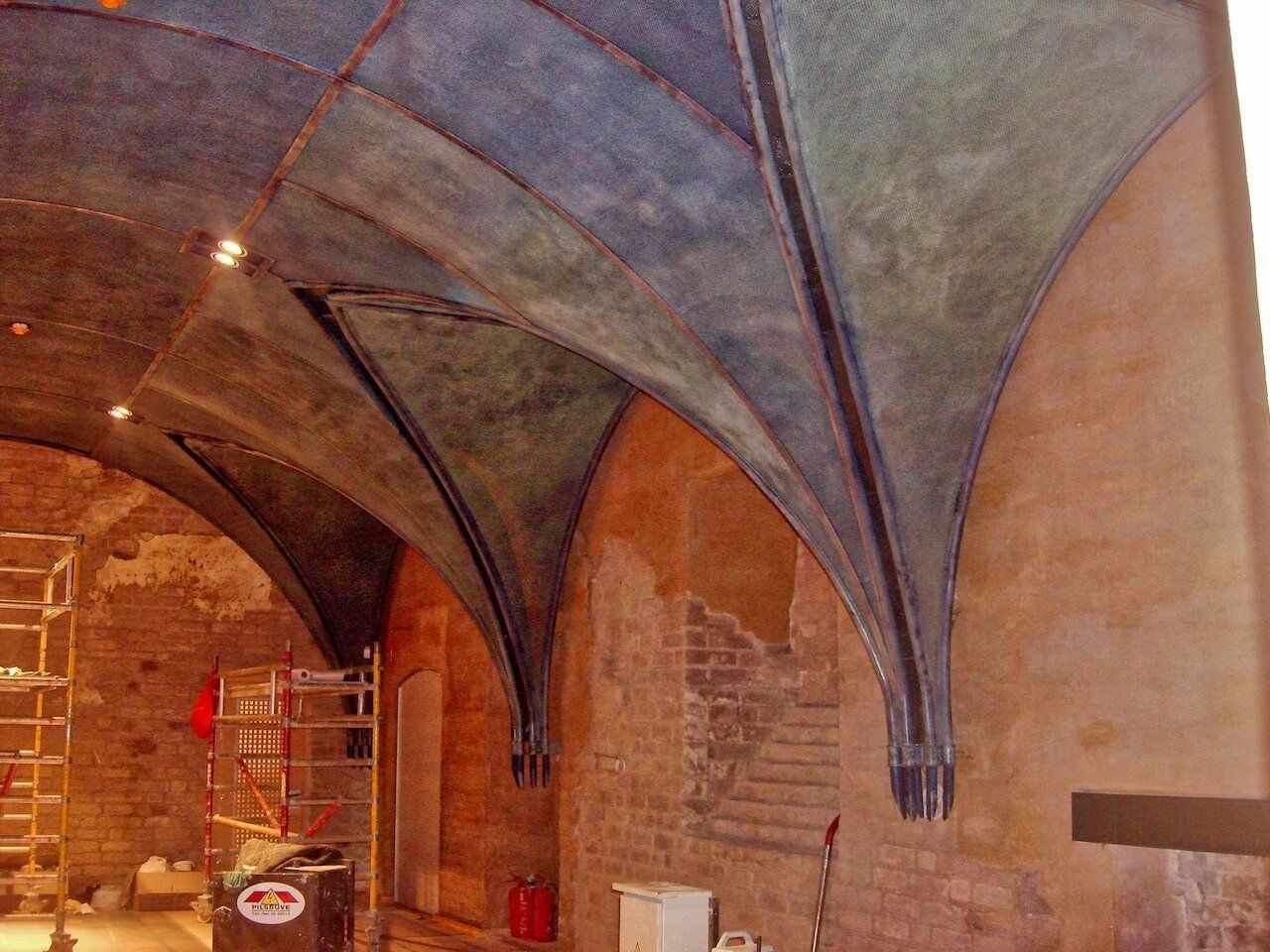 A very old building with arches and scaffolding