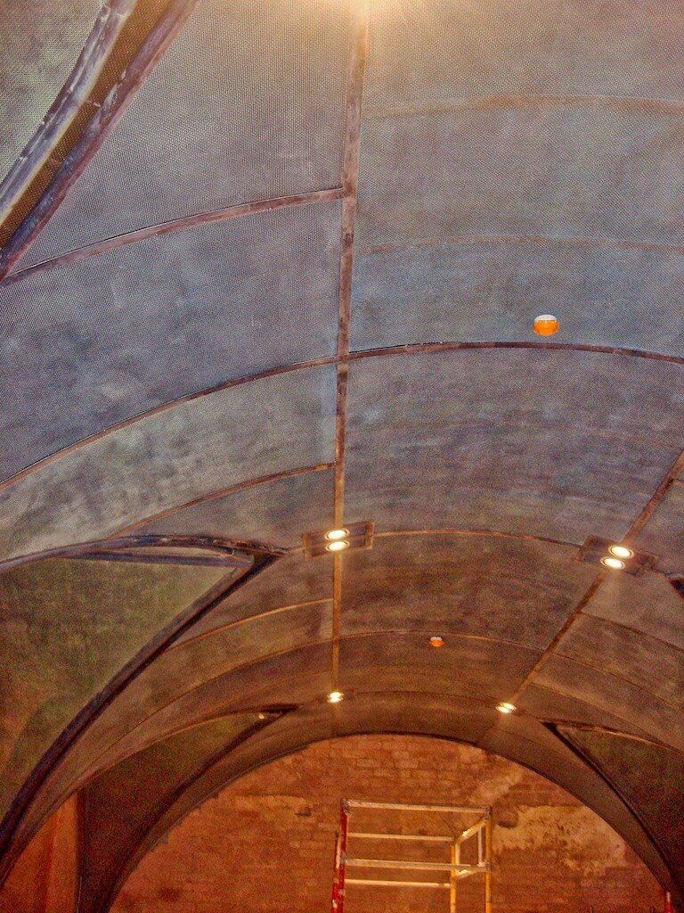 A ladder is hanging from the ceiling of a building.