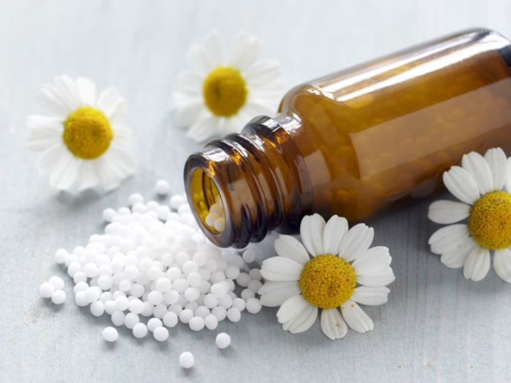 A bottle surrounded by flowers