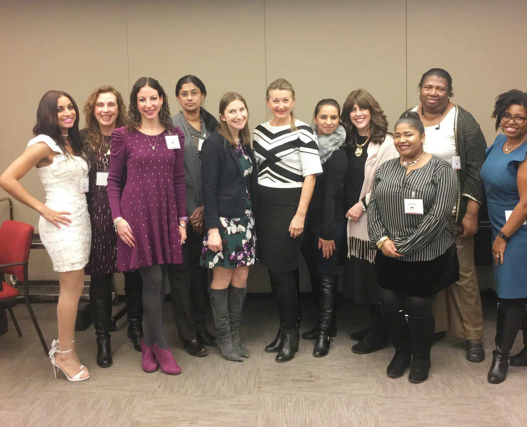 a group of women are posing for a picture together .