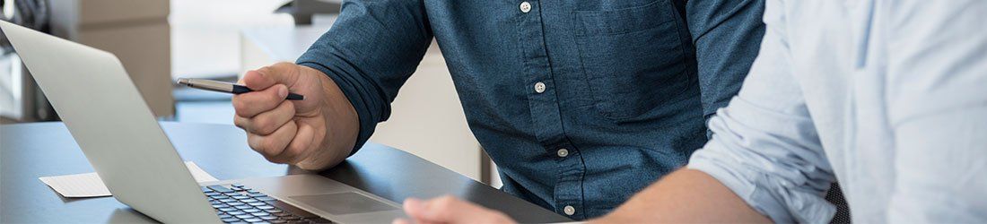 two men looking at laptop