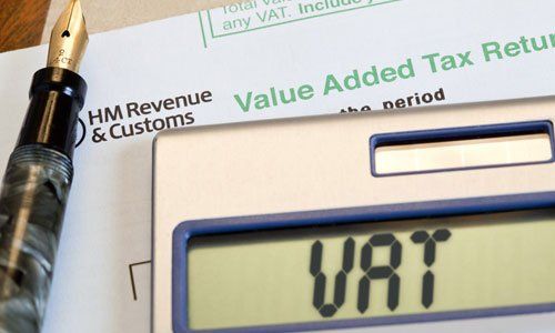 HM Revenue & Customs VAT return form with calculator and pen on top