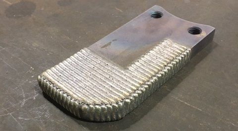 A piece of metal is sitting on top of a table.