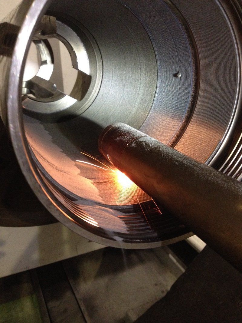 A person is holding a piece of metal in their hand.