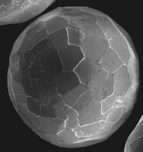 A black and white photo of a sphere with a hole in the middle