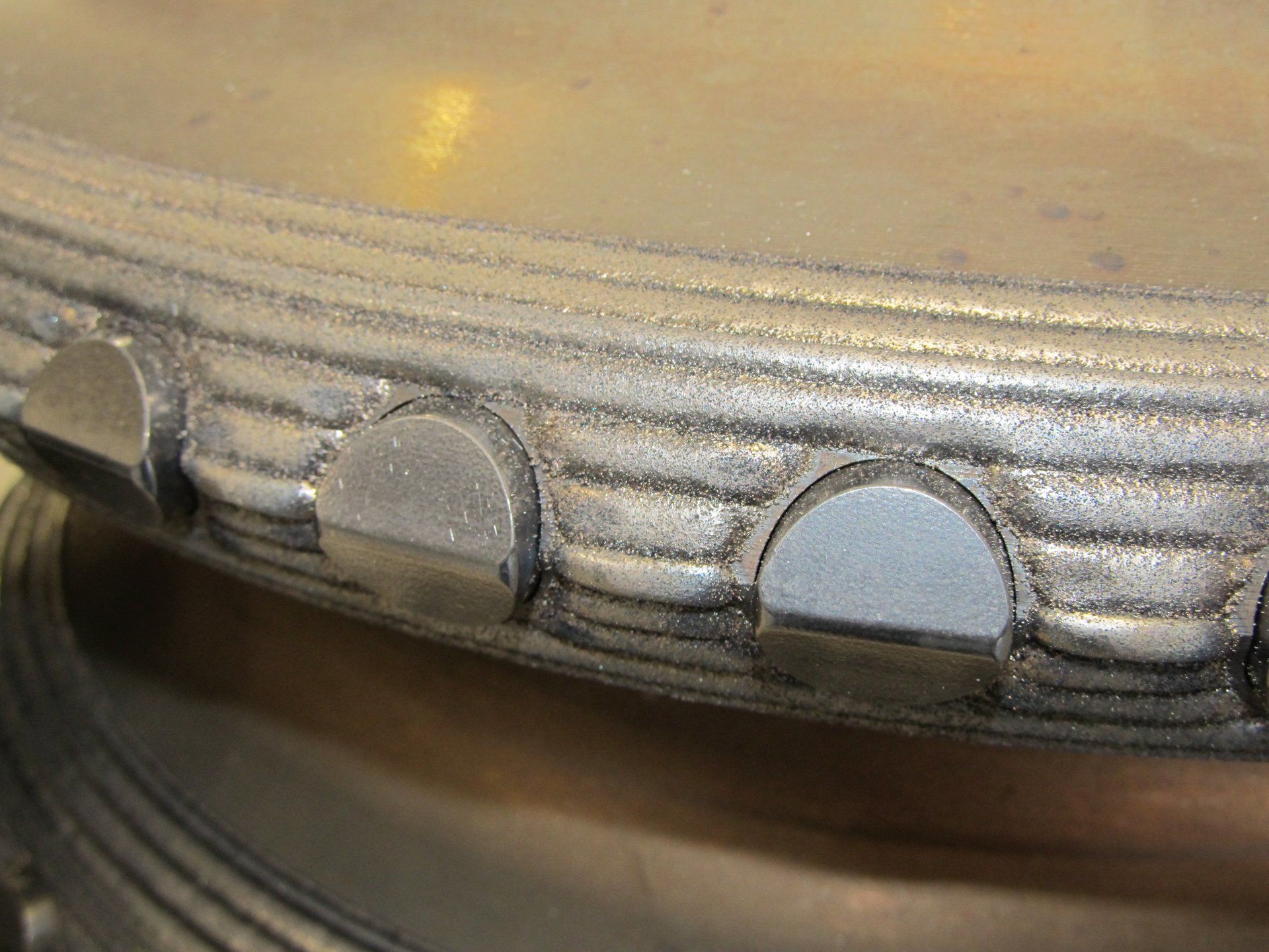 A close up of a metal object with a circular design on it.