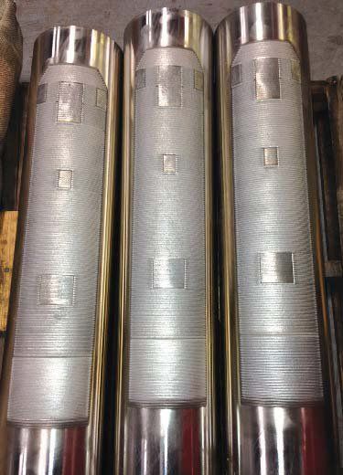 Three stainless steel pipes are stacked on top of each other