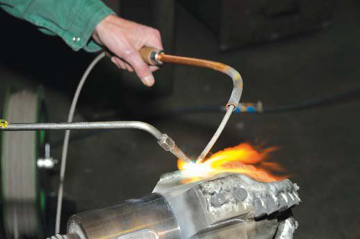 A person is cutting a piece of metal with a torch.