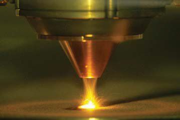 A close up of a laser cutting machine cutting a piece of metal.