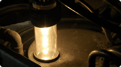 A close up of a light bulb in a dark room.