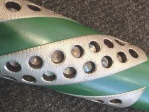 A close up of a green and silver object with holes in it.