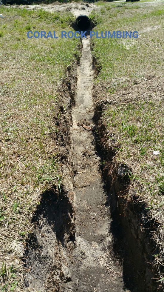 Excavate trench drain and re sod washed out fill next to building with sod from trench drain Trench Drain Water Jetting, Plumber Palm Bay Melbourne FL