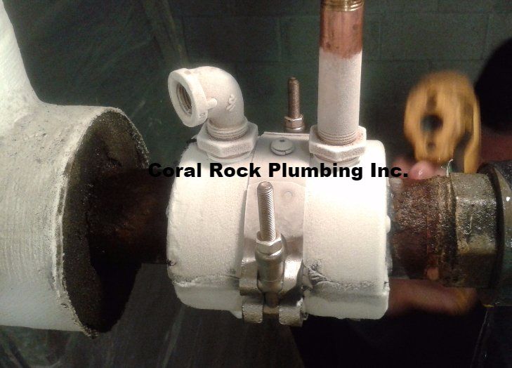 A coral rock plumbing inc. logo is on a pipe