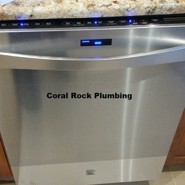 A stainless steel dishwasher with coral rock plumbing 