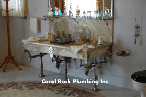 Flagler House A bathroom with a sink and a toilet and coral rock plumbing inc. written on the bottom