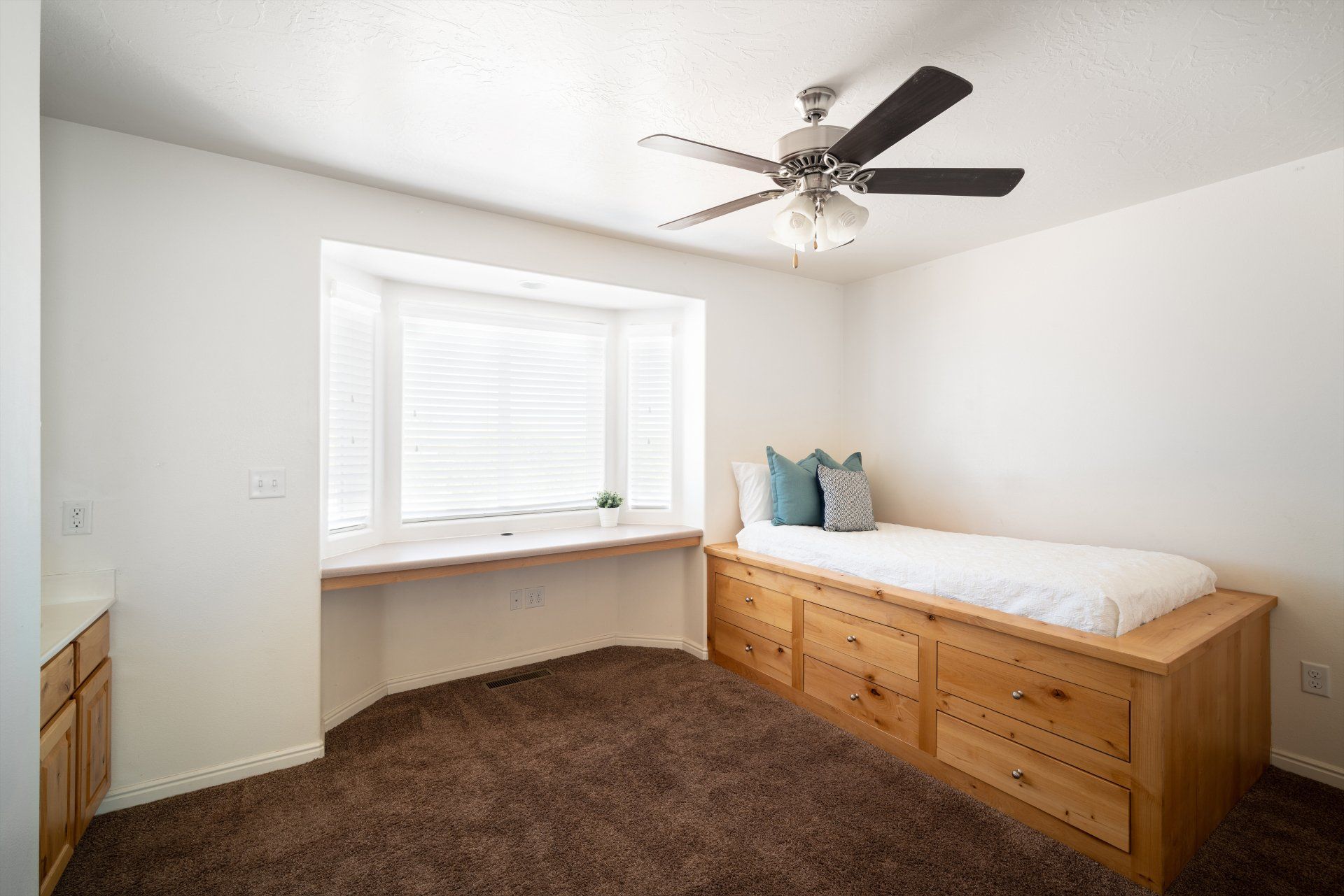 Large furnished private bedroom near Utah Tech University. Includes bed, vanity sink, desk, closet, and mini fridge.