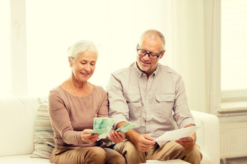 Couple checking their retirement investment plan with Bridex Accounting.