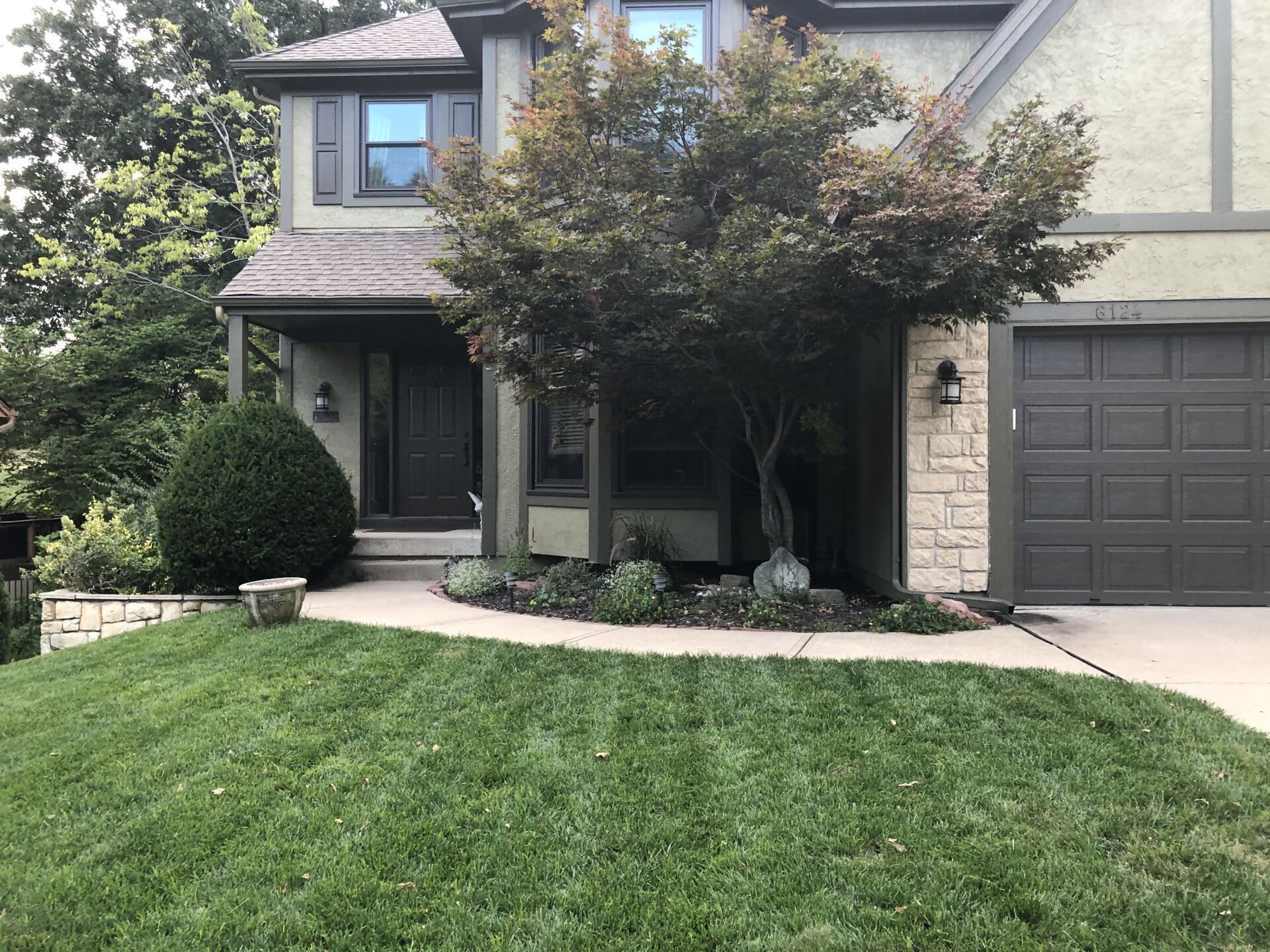 A large house with a large lawn in front of it.