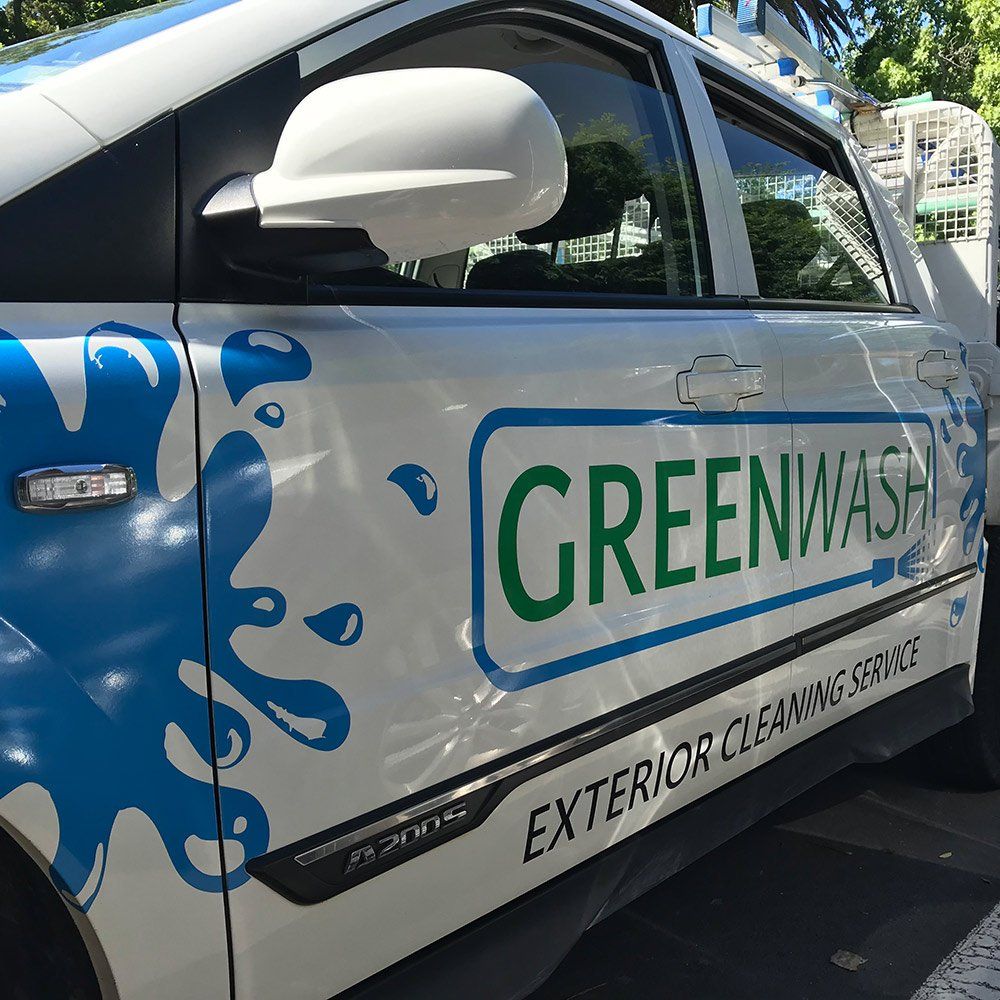 A white car with the word greenwash on the side